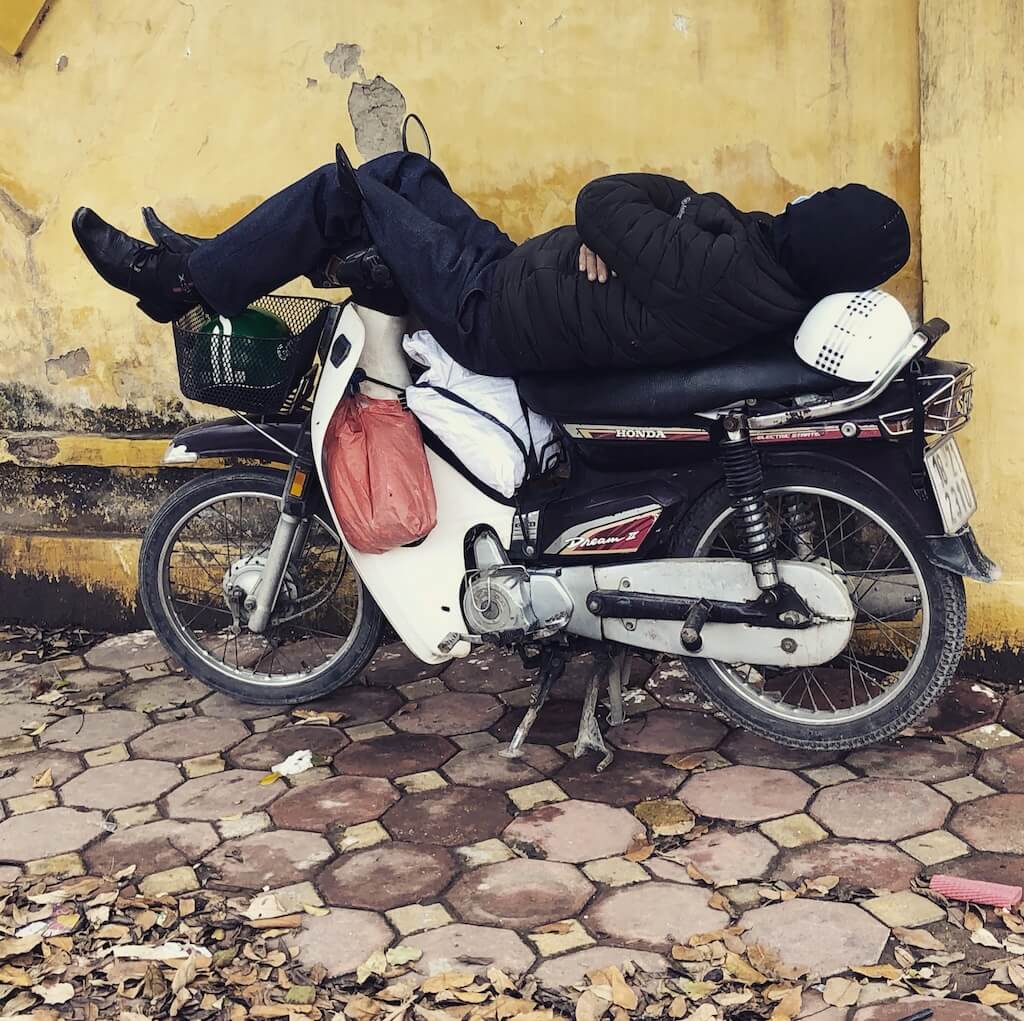バイクの上で器用に寝ているおじさん